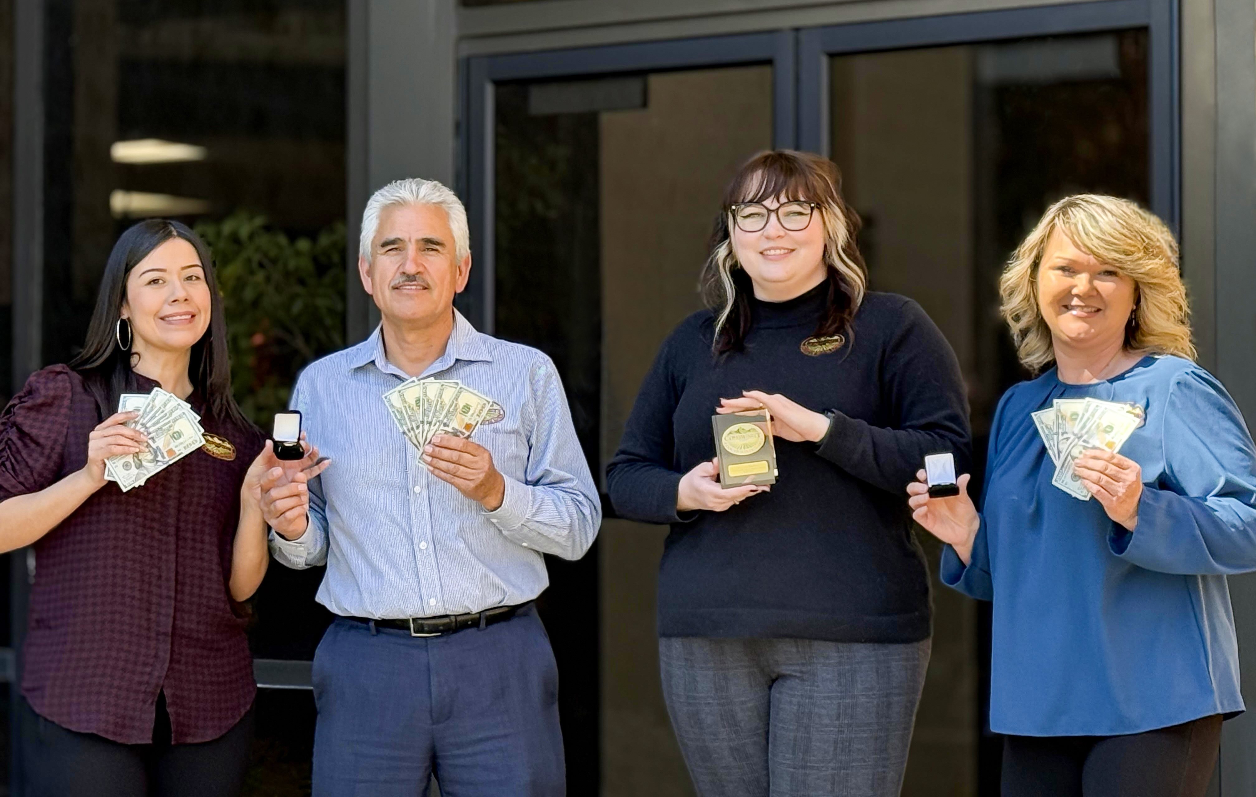Photo of employees holding various items